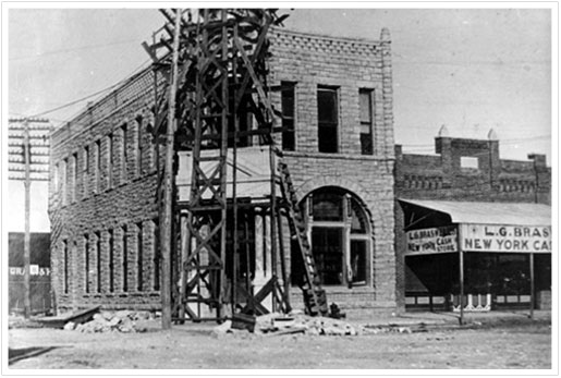 Exterior view of First National Bank building during reconstruction following fire in 1902
